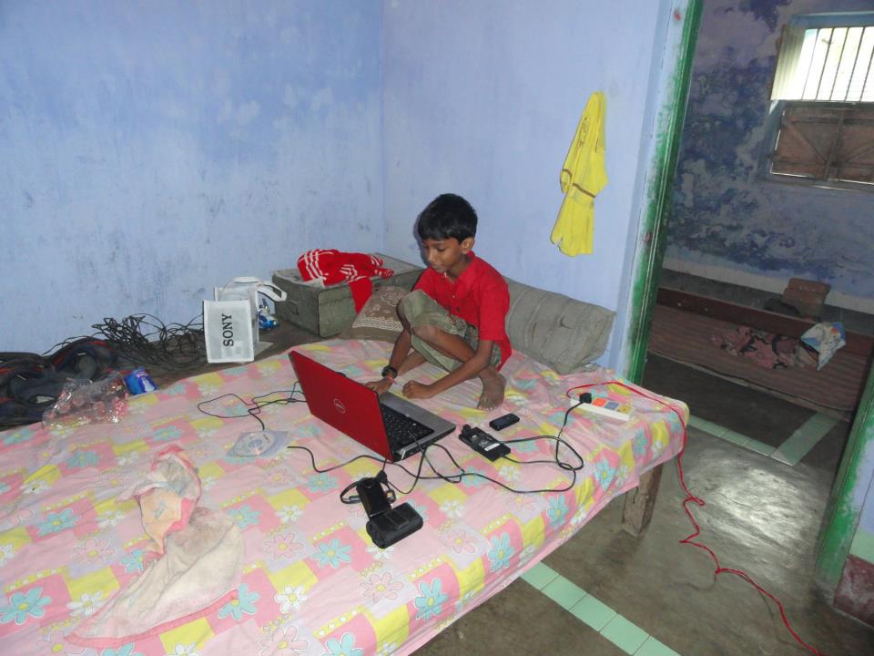 Young Priyam Raj using a laptop